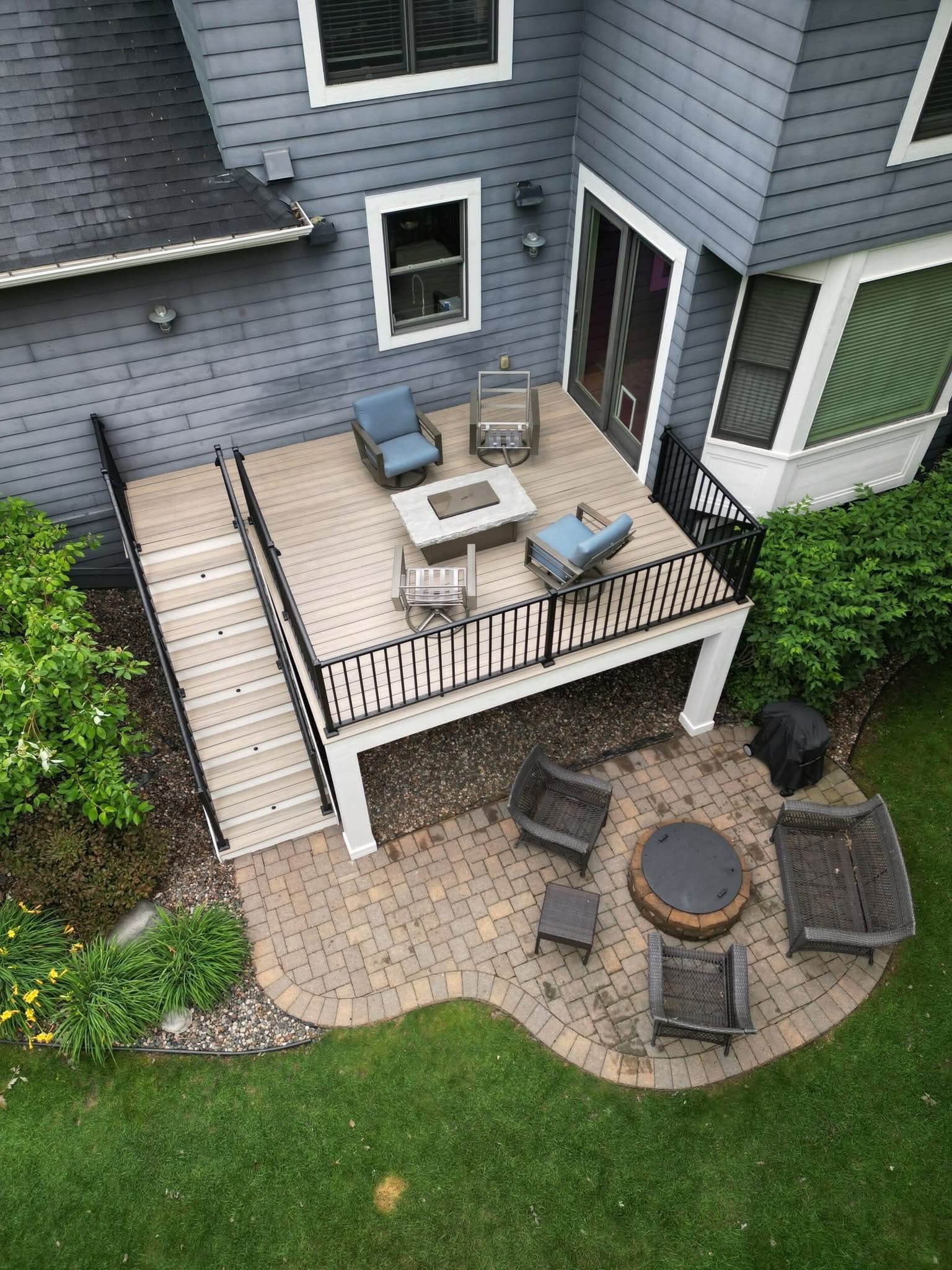 Deck with an adjoining paver patio, fire pit and seating area