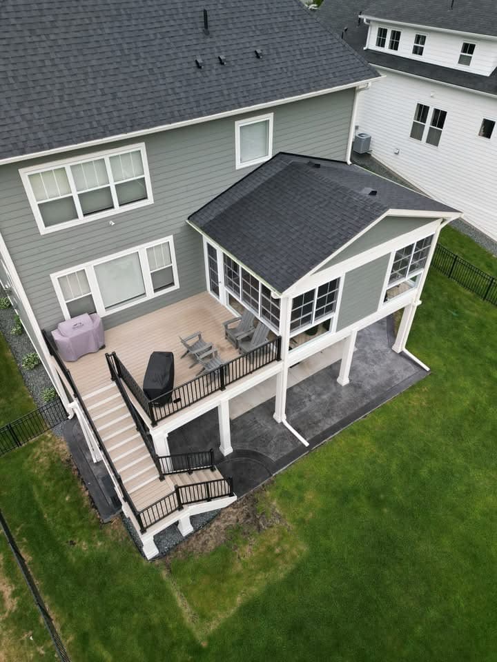 Deck with a screened porch addition and Adirondack chairs