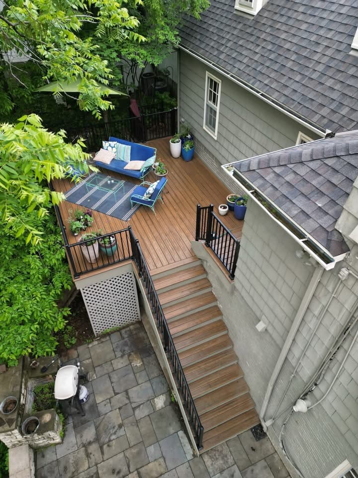 Natural wood-tone deck with stairs and outdoor furniture